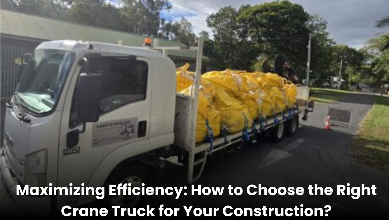 Crane truck lifting materials at a construction site with workers around